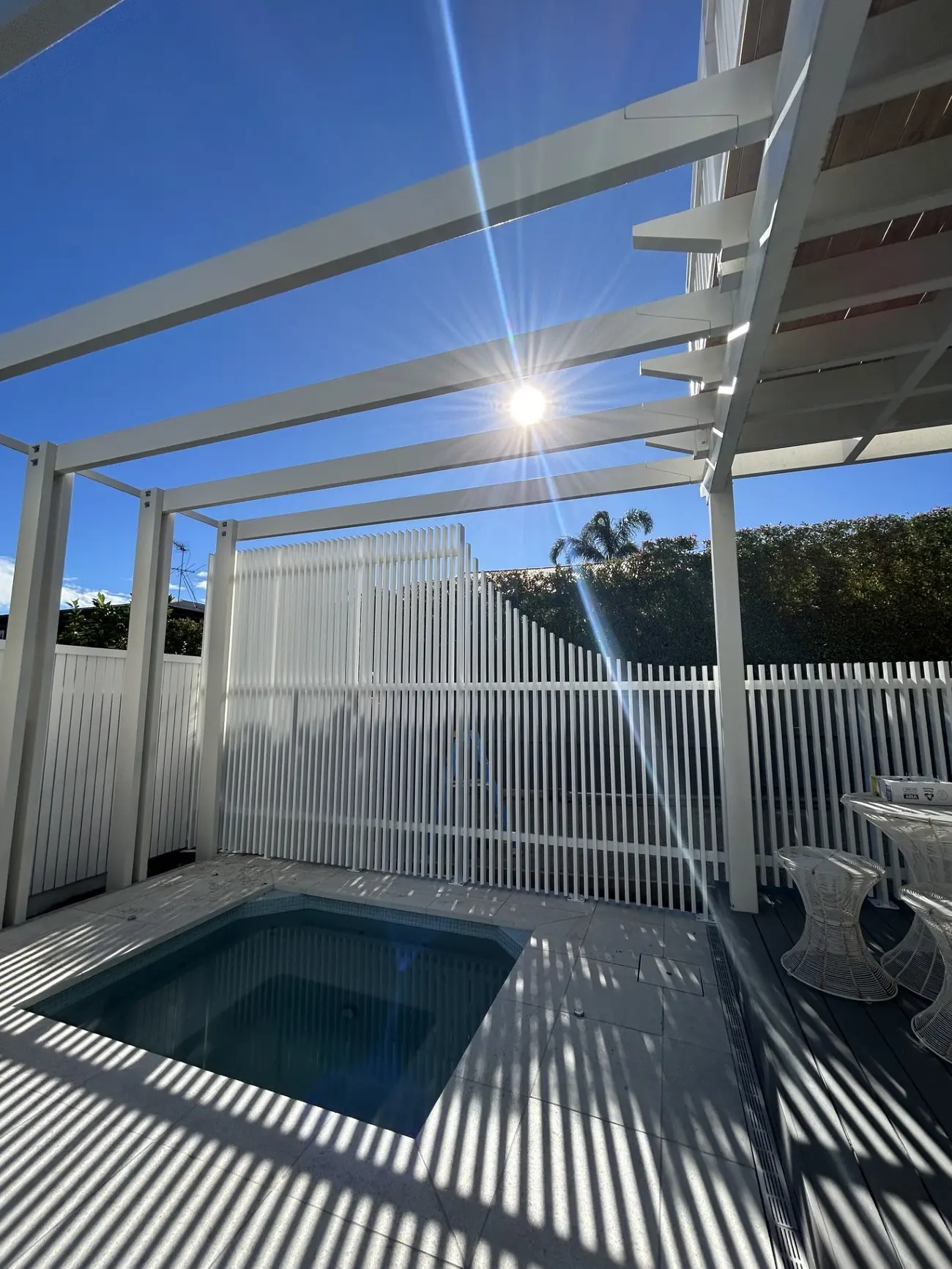 Spa under a white pergola by Professional Fitouts